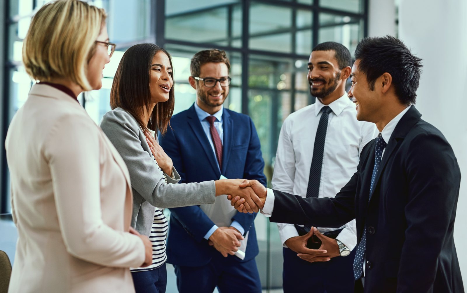 An advisor greeting a client with a handshake